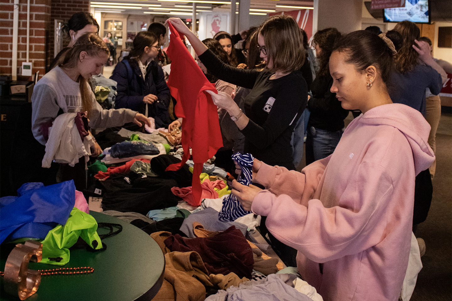 Students go through piles of clothing