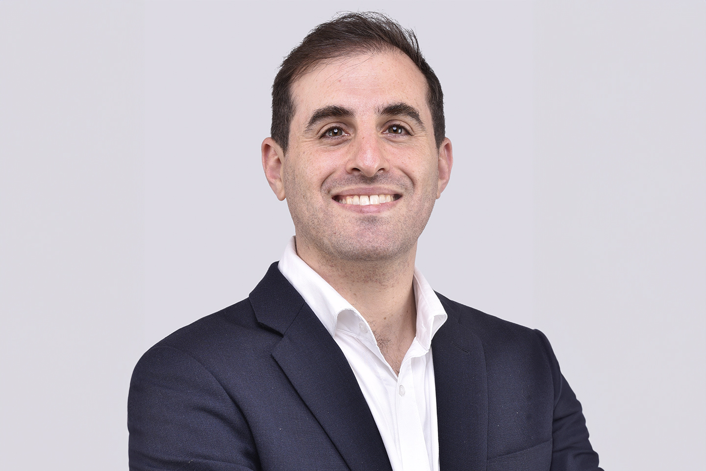 A headshot of a man in a suit