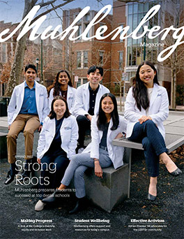 A magazine cover that says Muhlenberg Magazine with a group of dental students in white coats on the cover