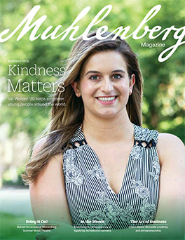 A magazine cover that says Muhlenberg Magazine with a portrait of a college student on the front