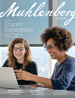 A magazine cover that says Muhlenberg Magazine with a photo of a college student and woman sitting in front of a laptop together