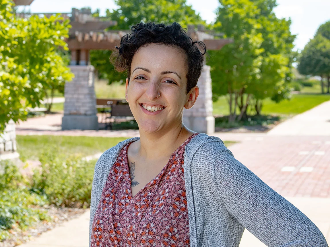 A headshot of a woman with short hair outside